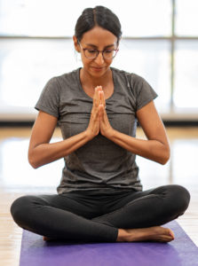 Monon Community Center member Nicole S. practicing grattitude in yoga at the MCC.