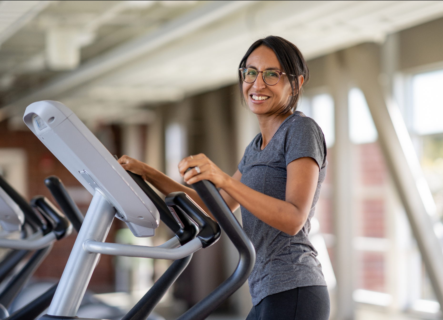 MCC Member Nicole S. on the eliptical in the Oasis at the Monon Community Center.