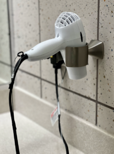 Hairdryer in the fitness center locker rooms attached to the wall