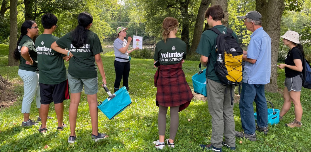 Volunteers receive training during a summer foray mushroom hunt volunteer event.