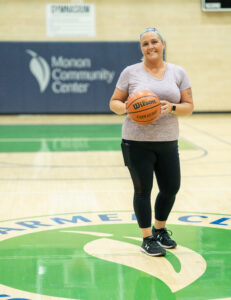 MCC Member Sharon with basketball in the gymnasium.