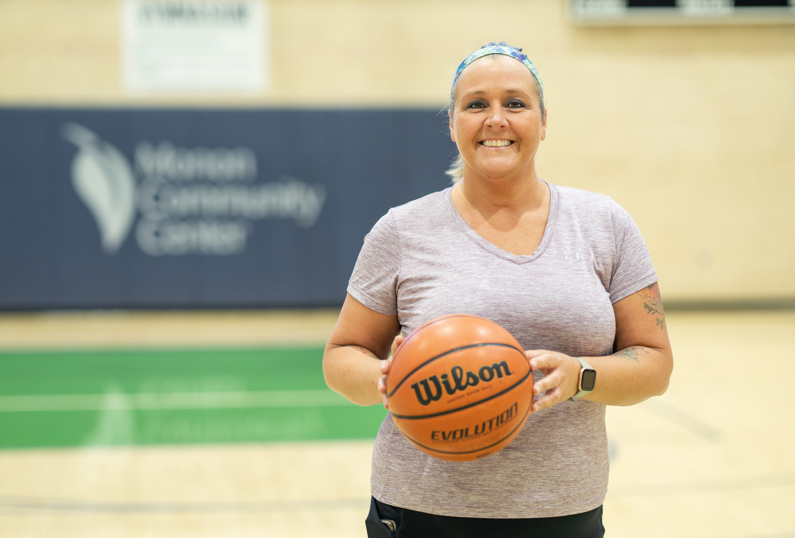 MCC Member Sharon with basketball in the gymnasium.