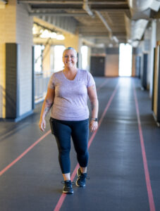 MCC Member Sharon smiles as she walks on the indoor track.
