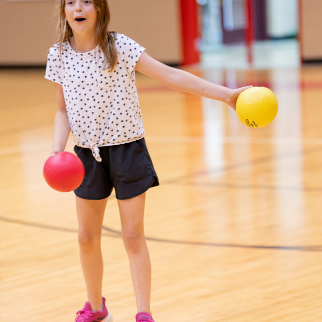 Girl shouting to her teammates while playing dodge ball at In the Zone summer camp.