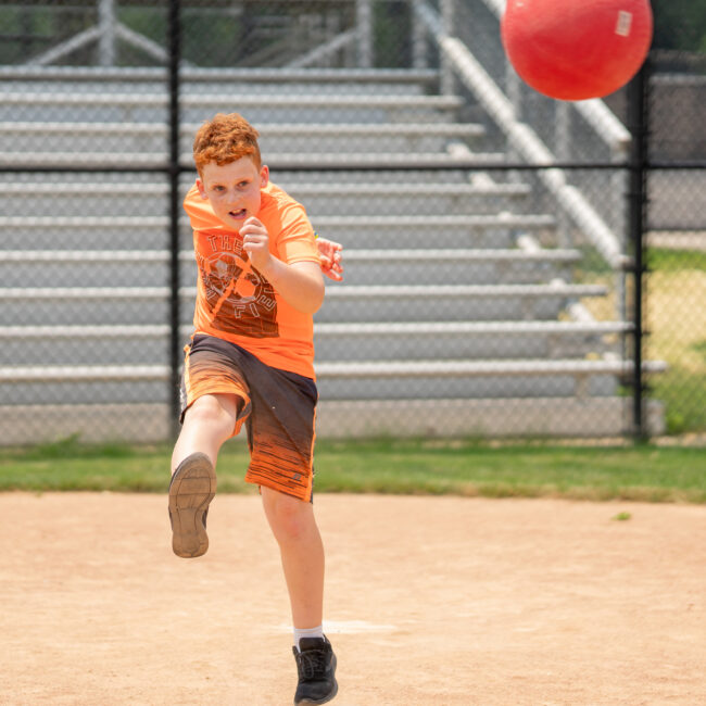 In the Zone camper launches the kickball.