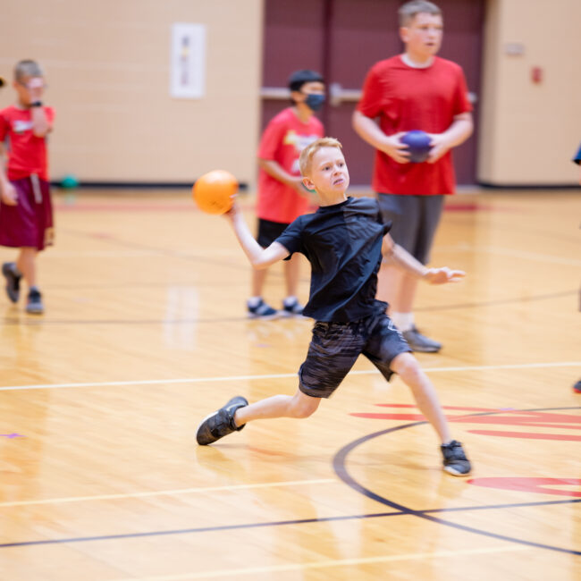 In the Zone camper hurls a dodgeball at opponents in the gym.