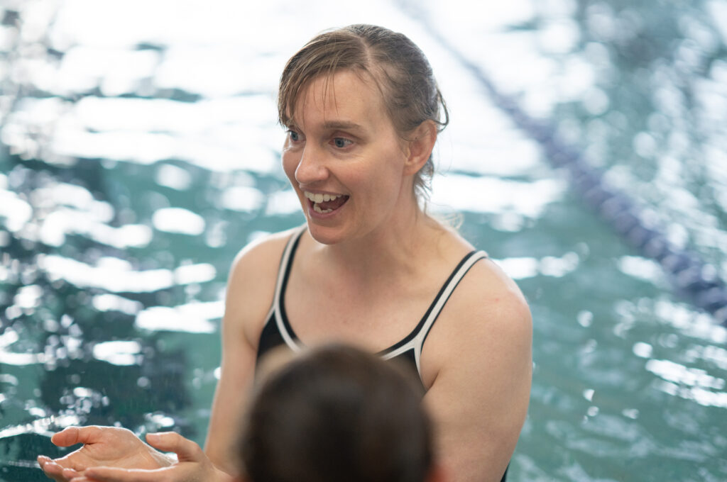 Aqua and group fitness instructor Gwen in the pool during an adult swim endurance class.