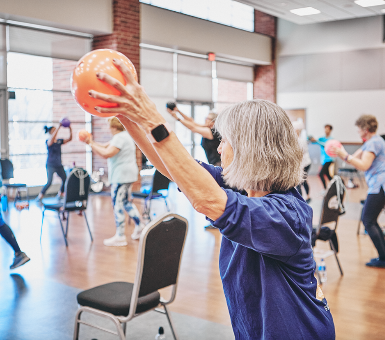 MCC members participate in a SilverSneakers group fitness class.