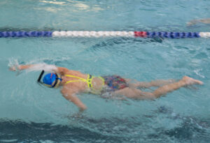 MCC member Robin W. swims a front stroke through the indoor lap lanes.