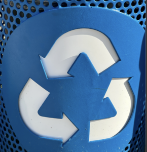 Blue recycling bin logo from a bin in the parks.