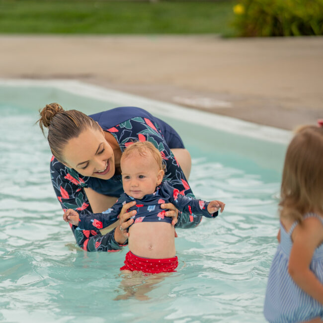 Mom and daughter in matching bathing suits at the kiddie pool at The Waterpark.