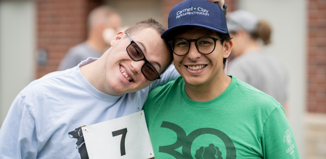 Inclusion Supervisor Kelvin with adaptive participant at the 5k race.