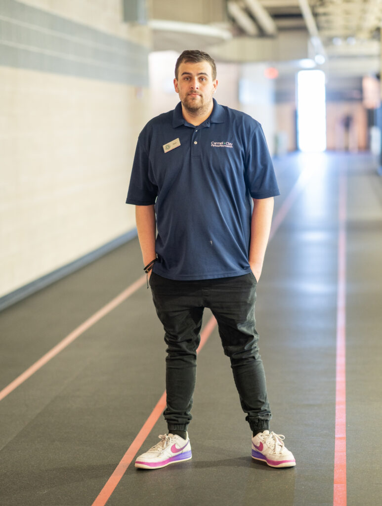 MCC Member Services Supervisor Ryan G. standing on the indoor track at the MCC.