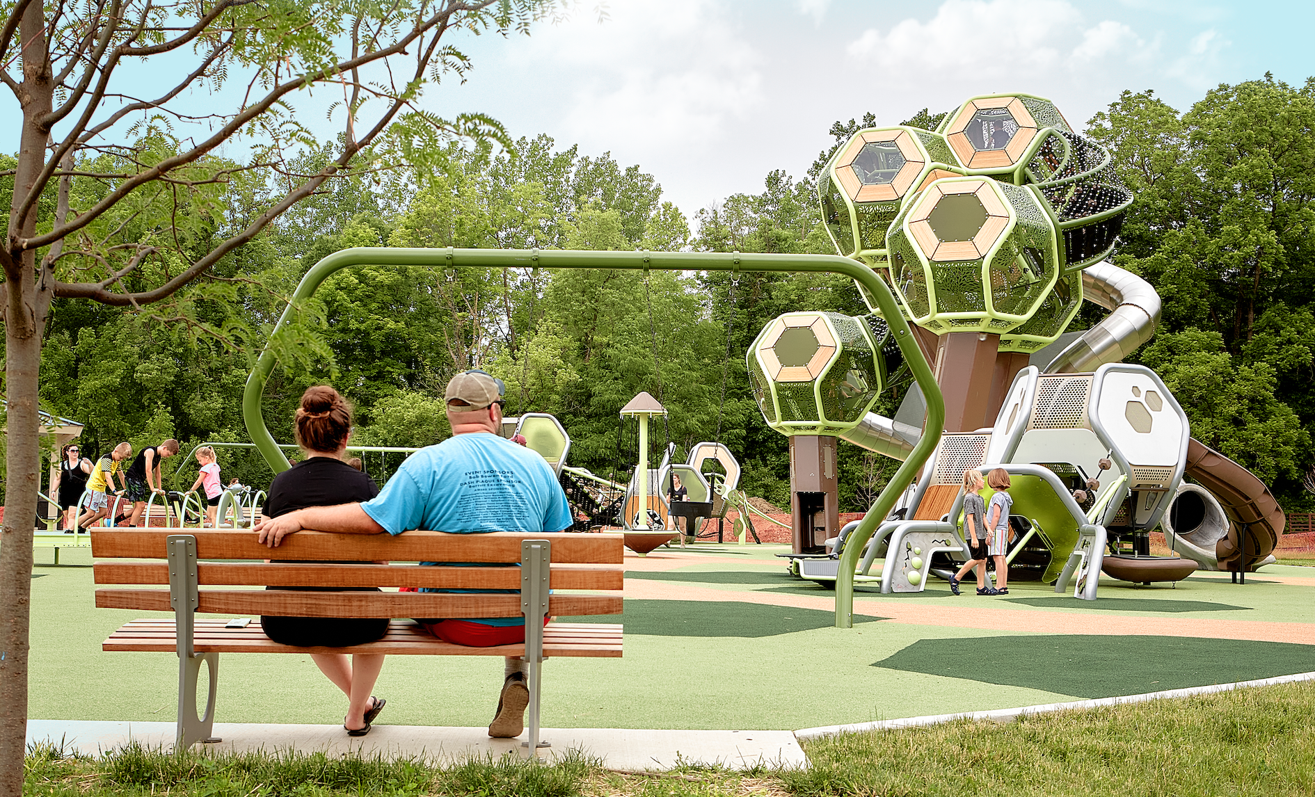 Park visitors sit on a bench at Meadowlark Park