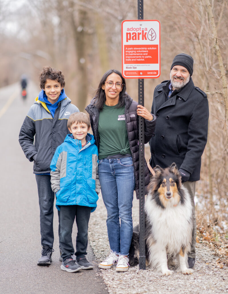Nicole Sipe and her family with their Adopt-A-Park sign along the Monon Greenway