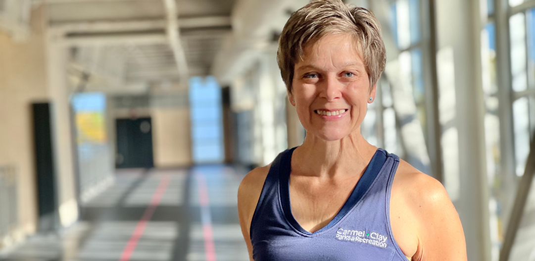 MCC Group Fitness Instructor Andrea S. poses for a photo on the indoor track.