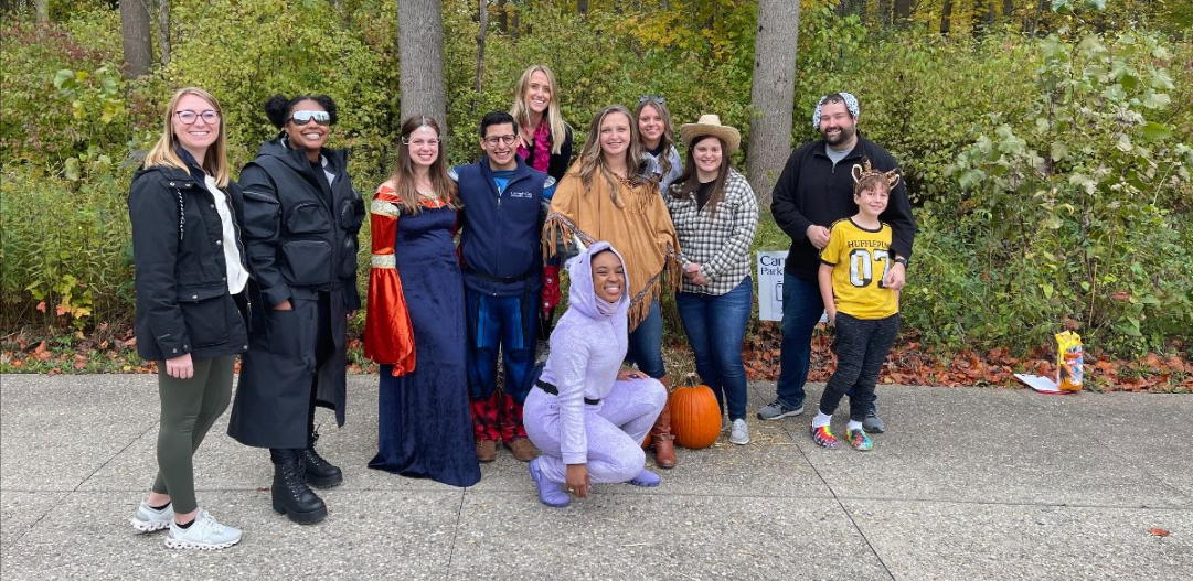 Group smiles in the woods during Sensory-Friendly Trick-or-Treat