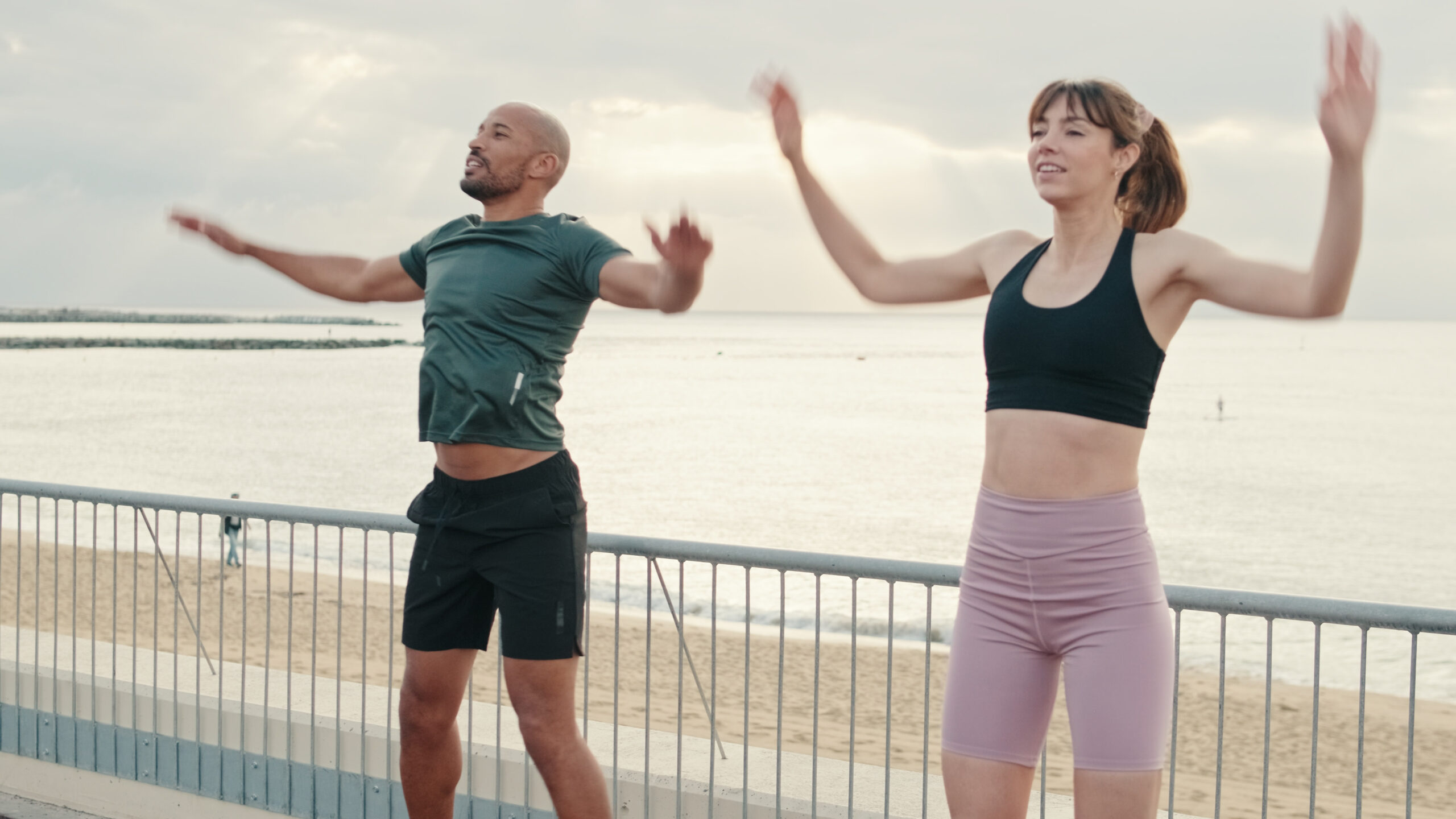 Two people dynamic stretching to warm up