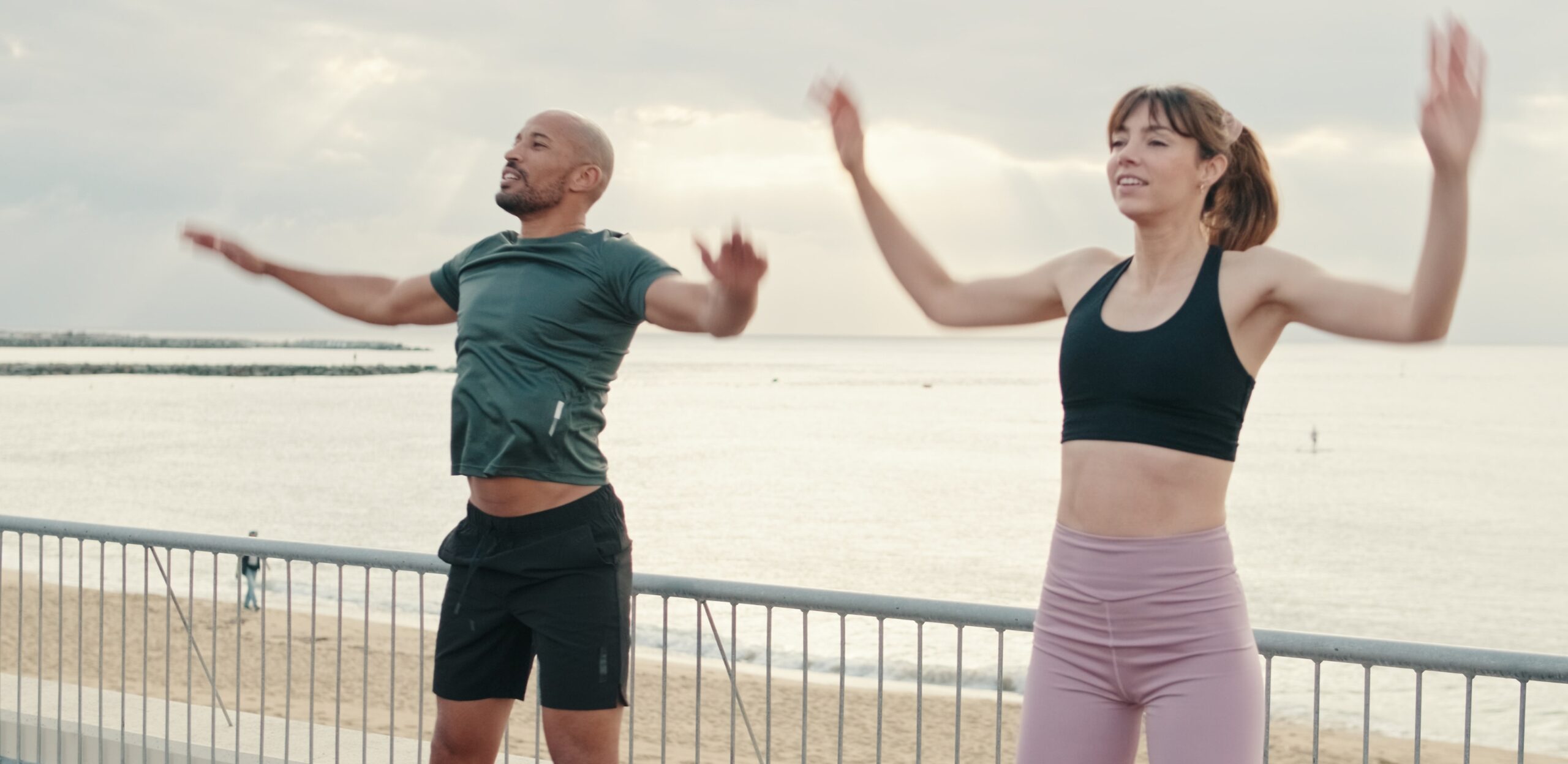 two people warming up by doing dynamic stretches